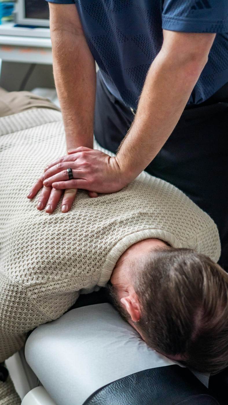 Chiropractor adjusting a patient's upper back and neck